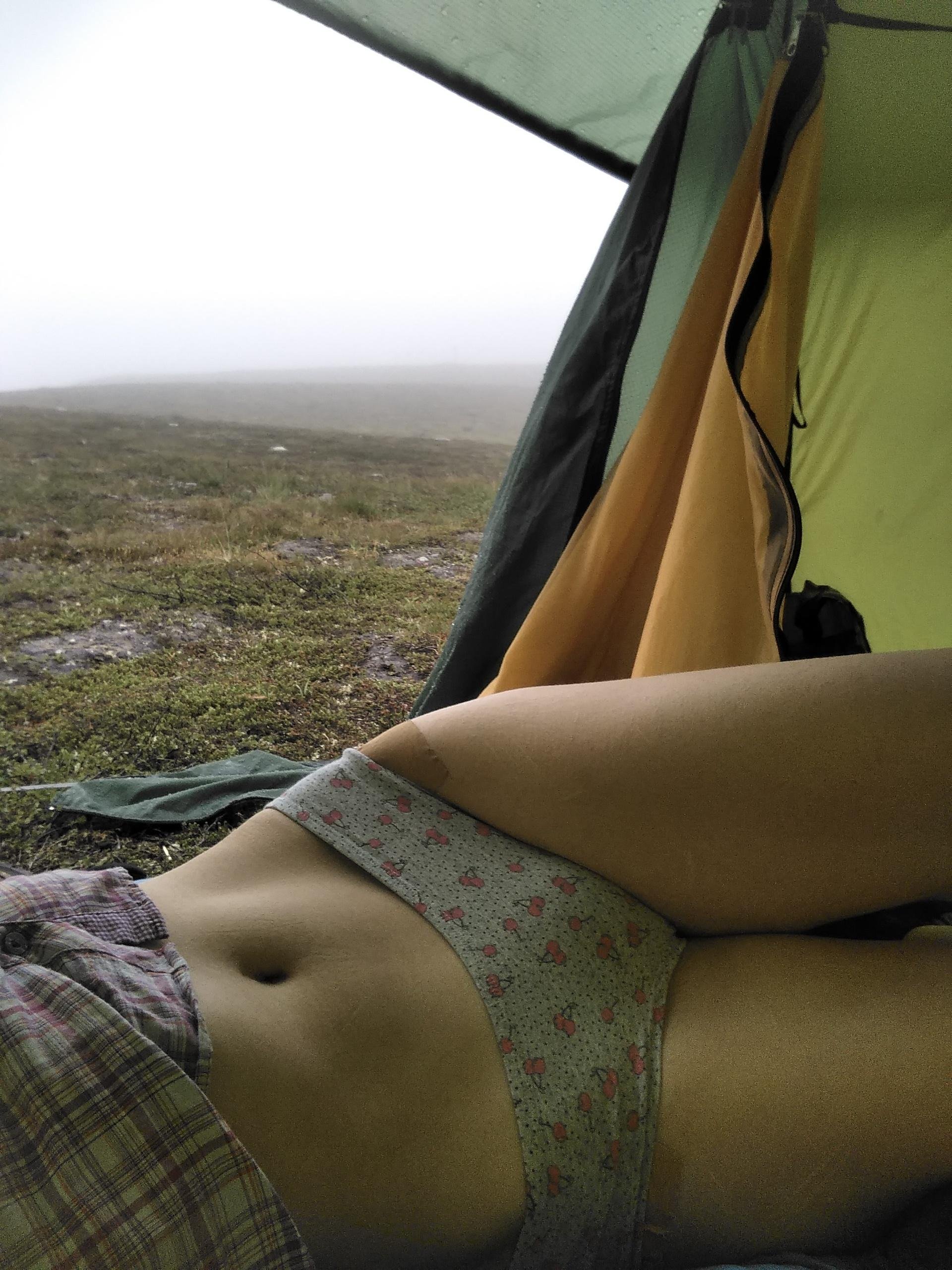 In the tent, in the rain, in the mountains. Should get dressed, pack up, and keep hiking. Don't wanna.