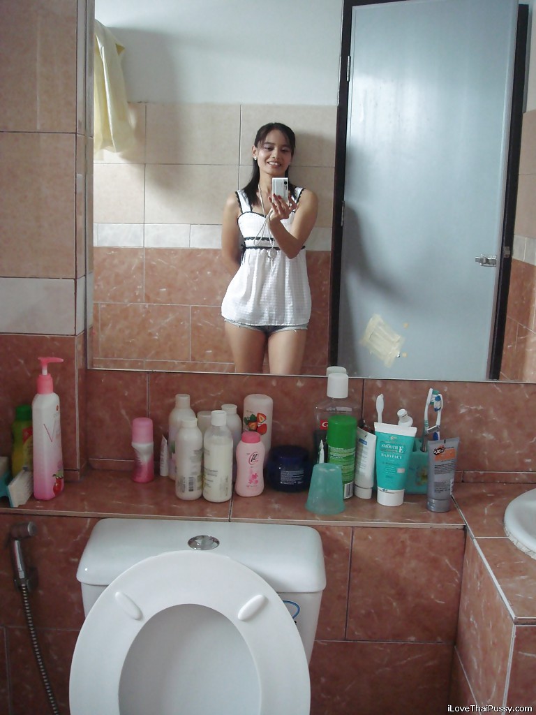 Petite Thai girl tales self shots before stripping naked in bathroom
