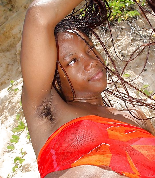 Coco, ebony girl showing hairy armpits and pussy
