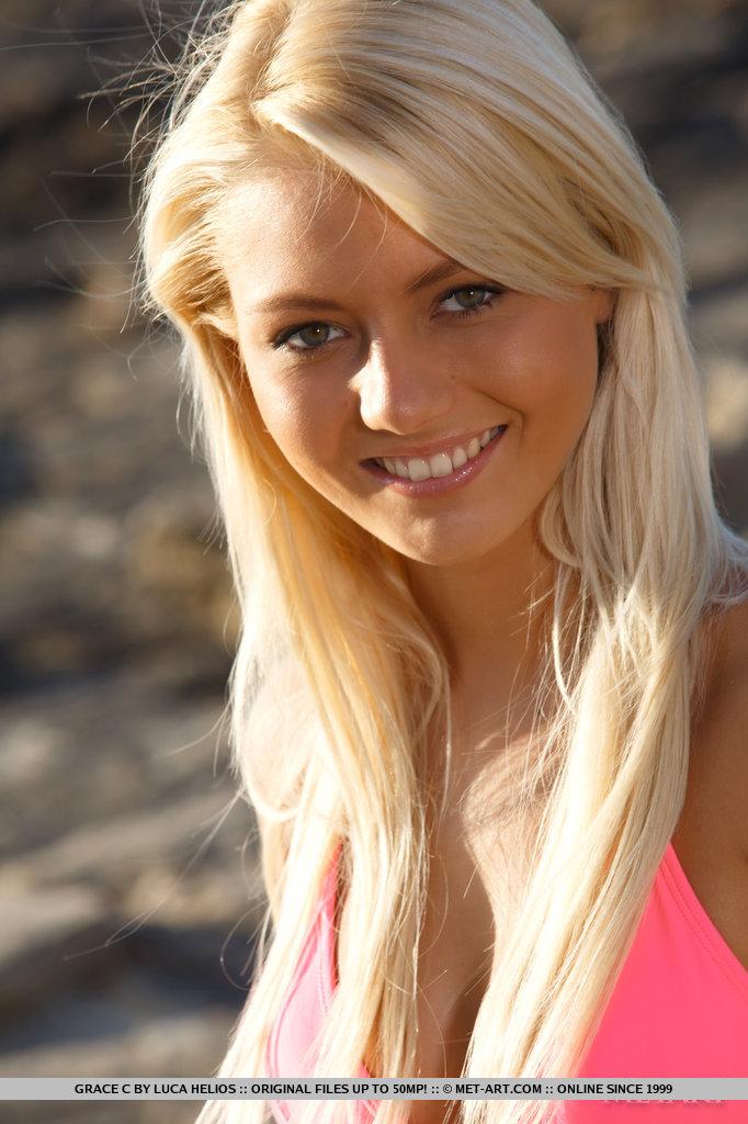 Pictures of tight blonde girl Grace C getting naked on a beach