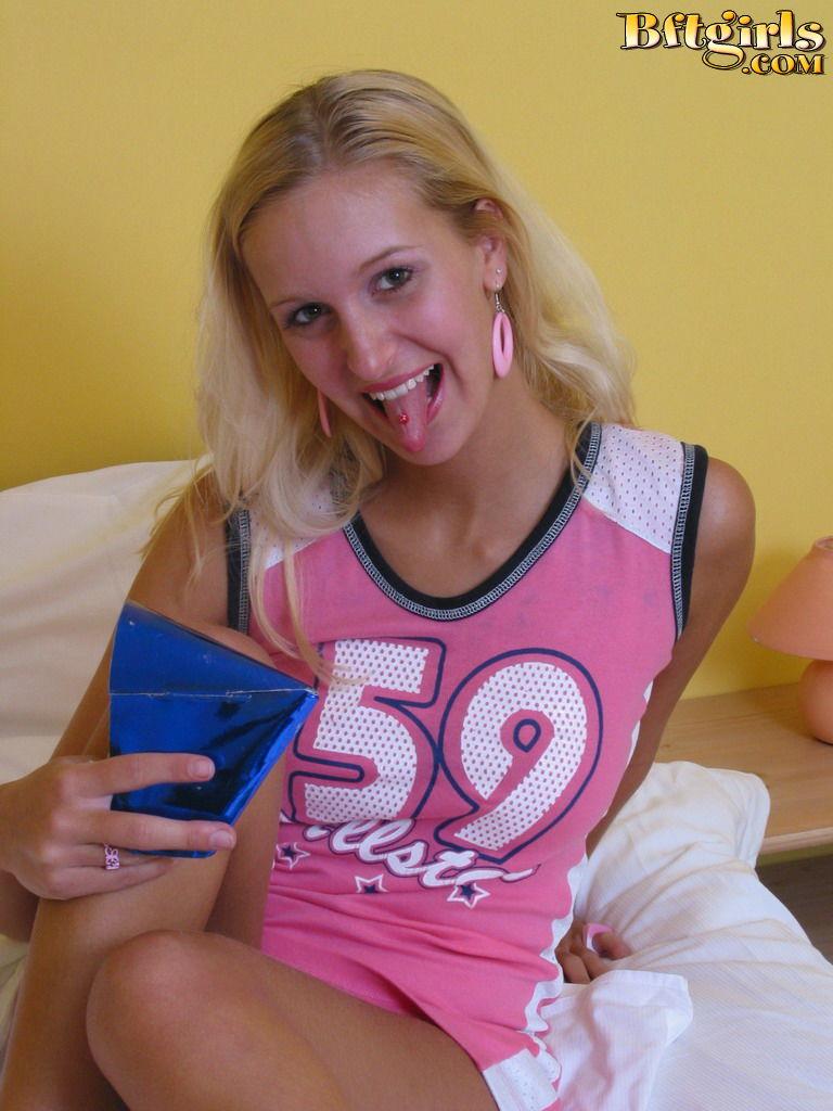 Beautiful blonde teen strips naked in bed and plays with her toes