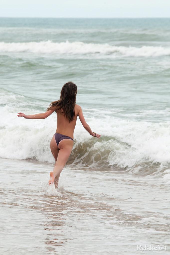 Pictures of hot teen girl Nedda enjoying her nakedness on a beach