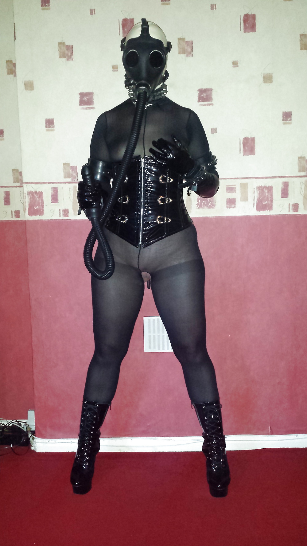 Slave girl in rubber gas mask and dildo hose
