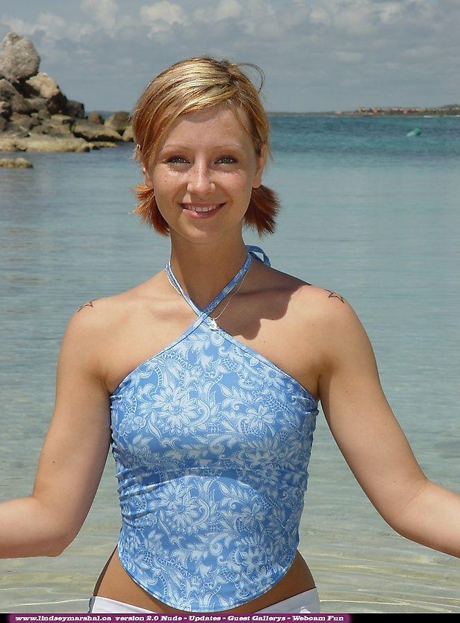 Pictures of teen Lindsey Marshal going for a skinny dip on a beach