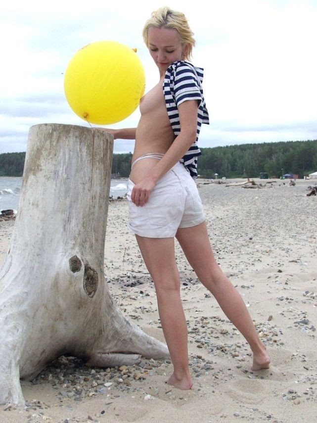 Blonde beach babe posing with a balloon