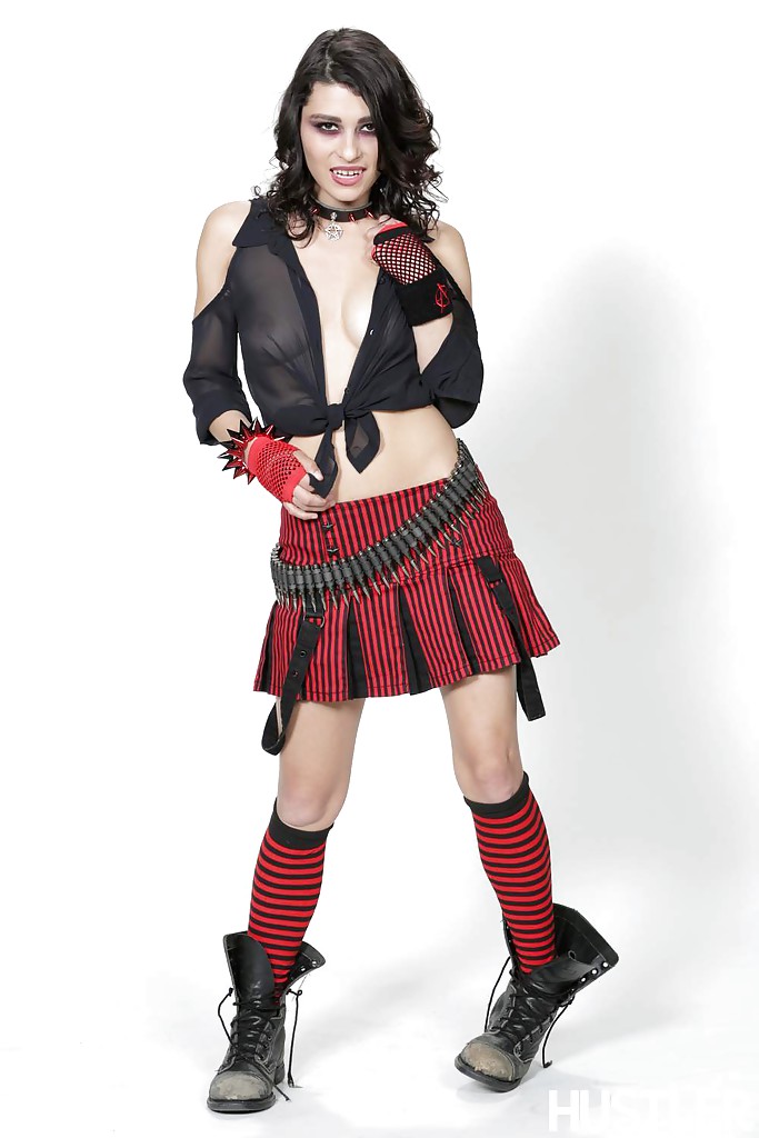 Outstanding brunette Raven Rockette is posing in her red skirt