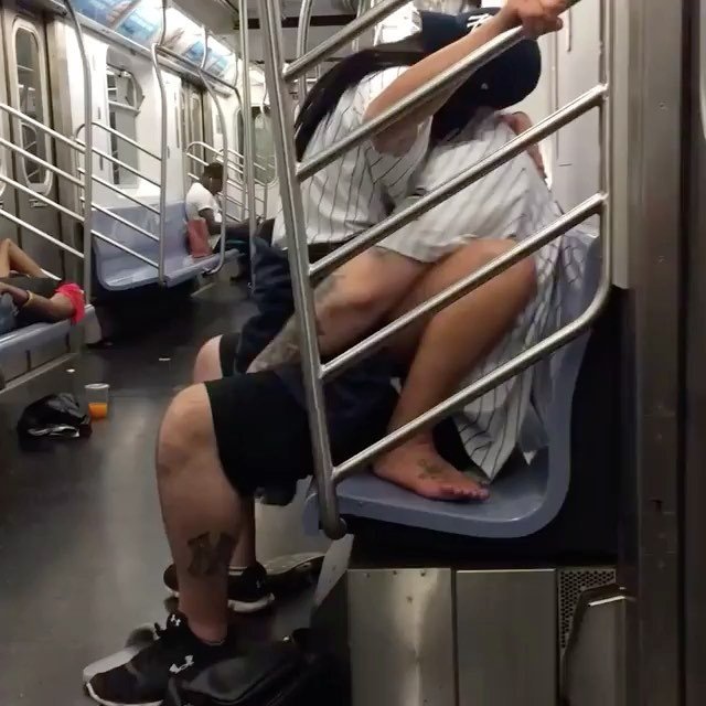 NY Yankees fans having some fun on the subway.