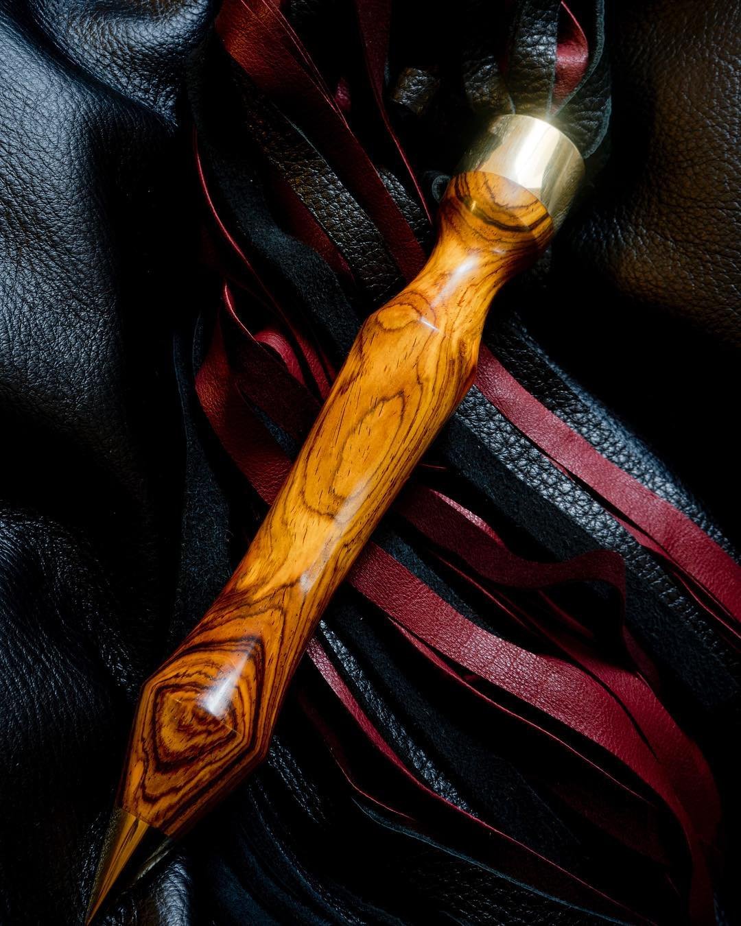 Strikingly bright cocobolo from our private reserve paired with redwood and black deer leather