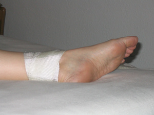 Naked tied feet during spreadeagle bondage